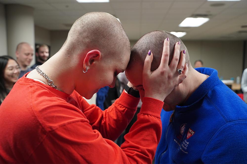 An image of the husband and wife who had their heads shaved
